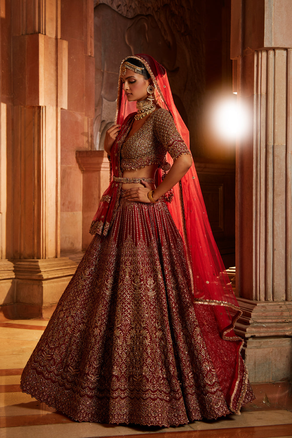 Jannat Khan In Blood Red Raw Silk Lehenga Choli and Belt with Tulle Dupatta with an Optional Lighter Second Dupatta