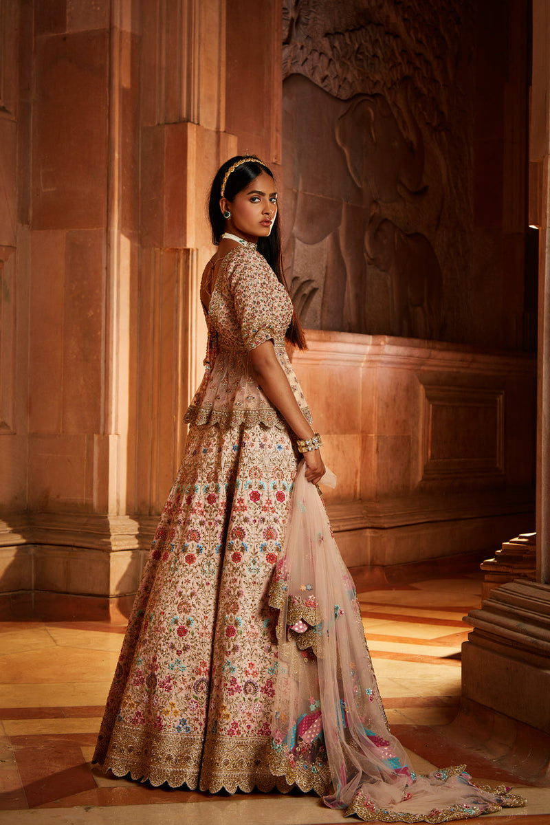 Blush Pink Raw Silk Lehenga with a Peplum Top and Tulle Dupatta