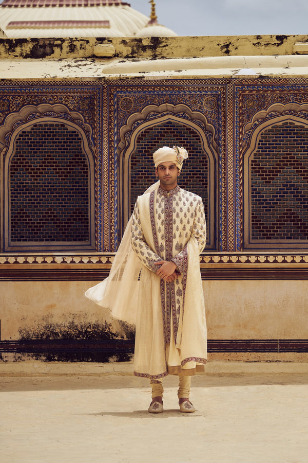 BEIGE RAW SILK SHERWANI WITH A COTTON SILK CHOGA AND CHURIDAR