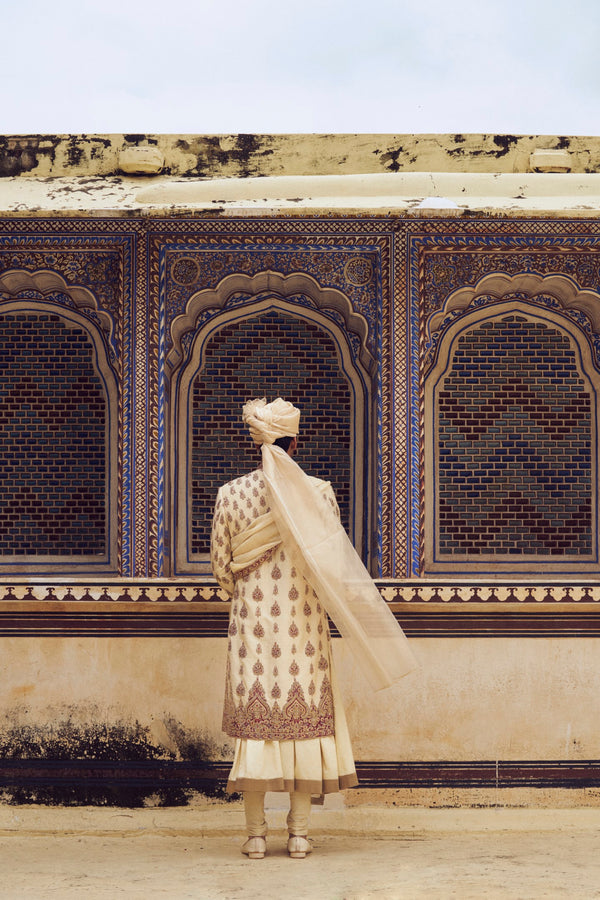 BEIGE RAW SILK SHERWANI WITH A COTTON SILK CHOGA AND CHURIDAR